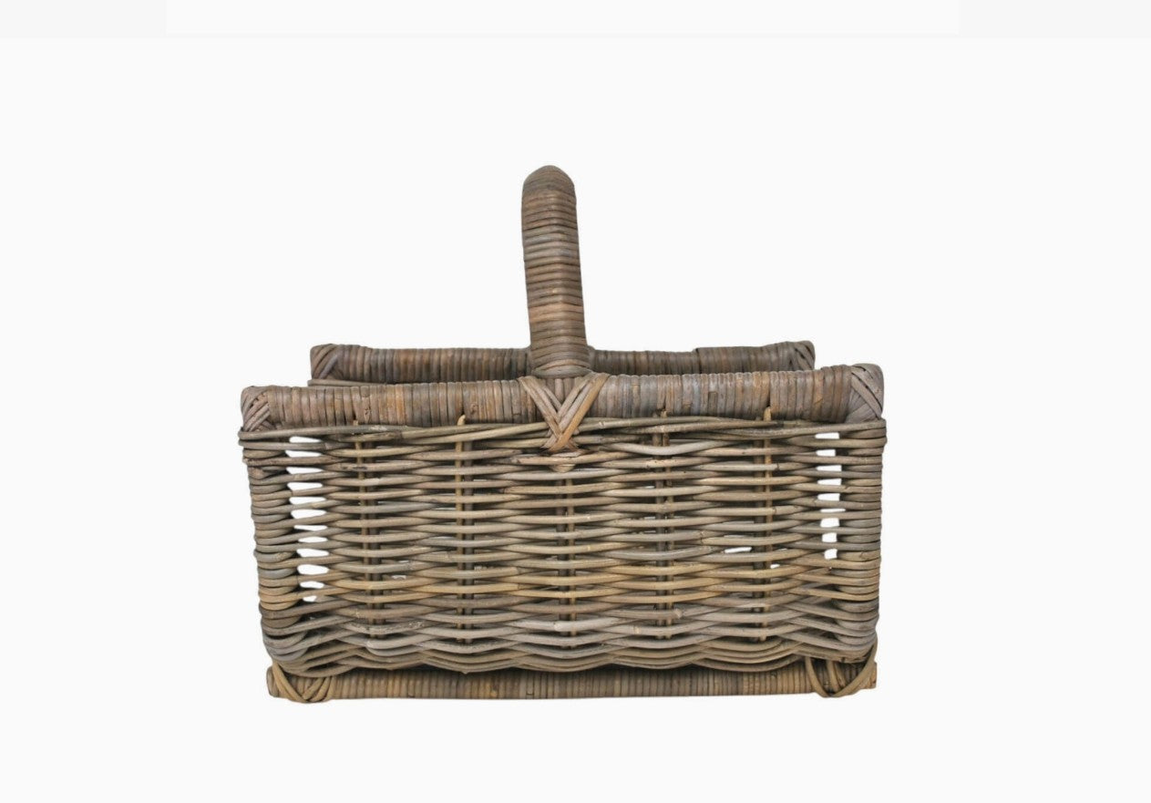 Wicker picnic basket with handle on a white background