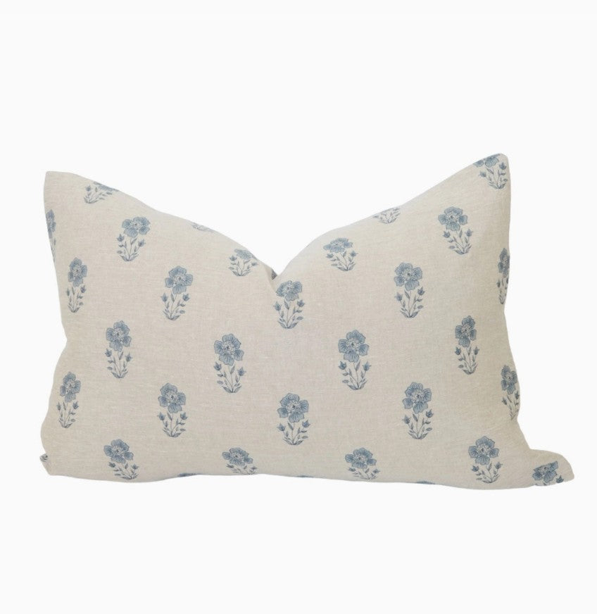 Decorative pillow with blue floral pattern on a white background