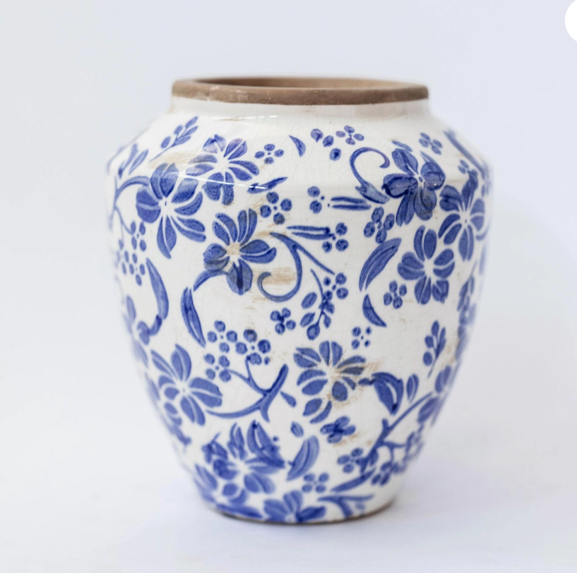 Ceramic vase with blue floral pattern on a white background