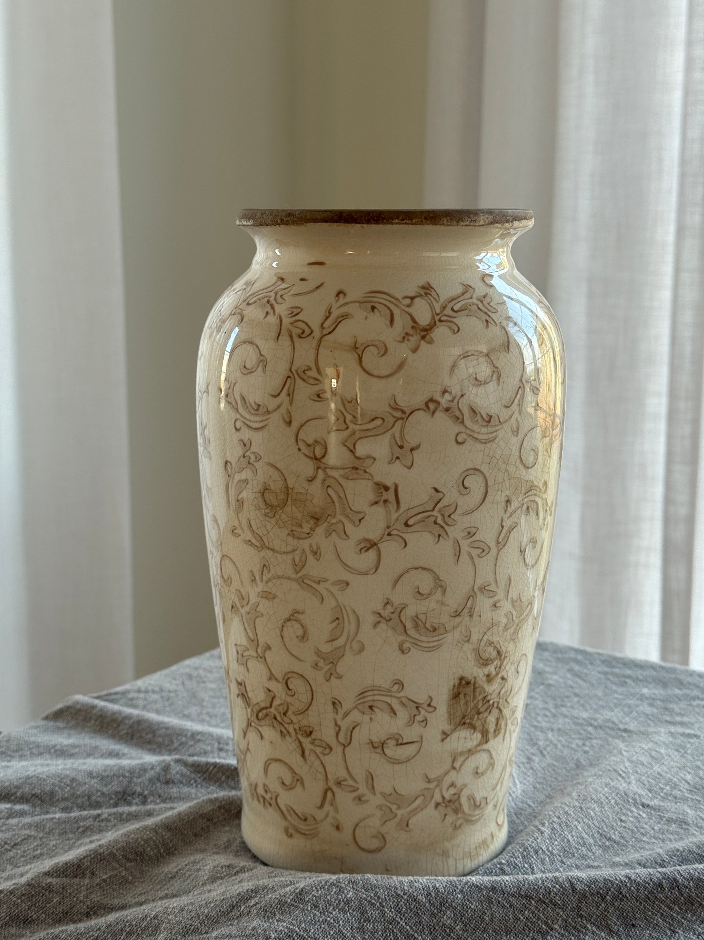 Decorative vase with intricate patterns against a neutral background