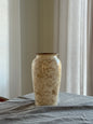 Decorative vase with intricate patterns on a neutral background