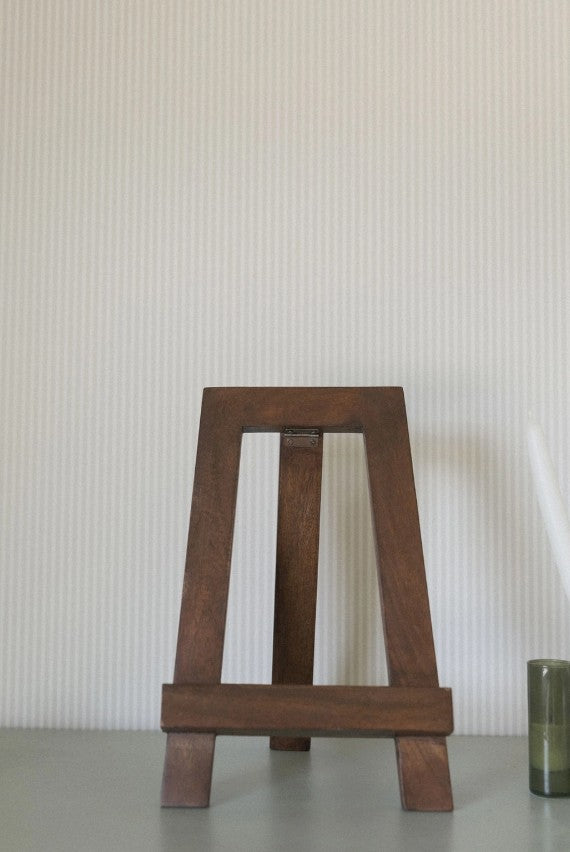 Wooden easel on a neutral background