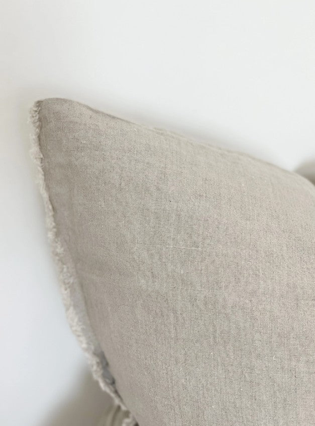 Close-up of a textured beige pillow on a white background