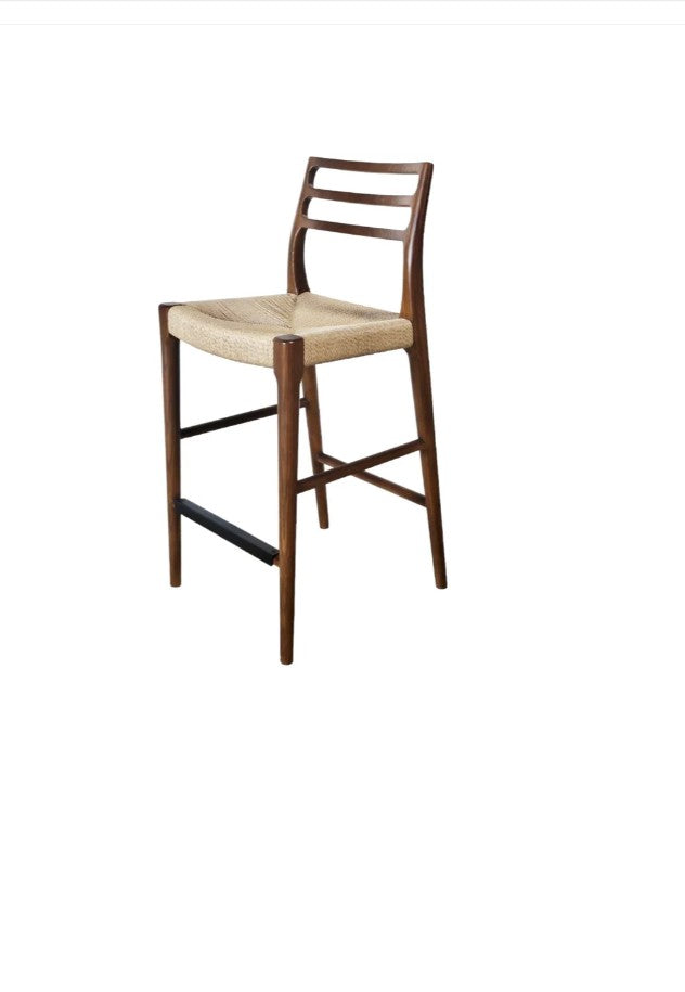 Wooden bar stool with a beige seat on a white background