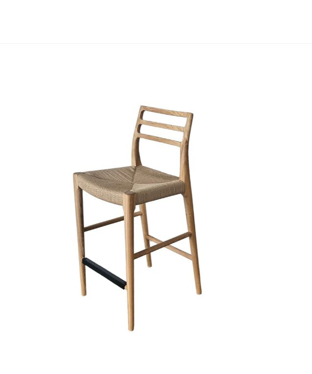Wooden bar stool with woven seat on a white background