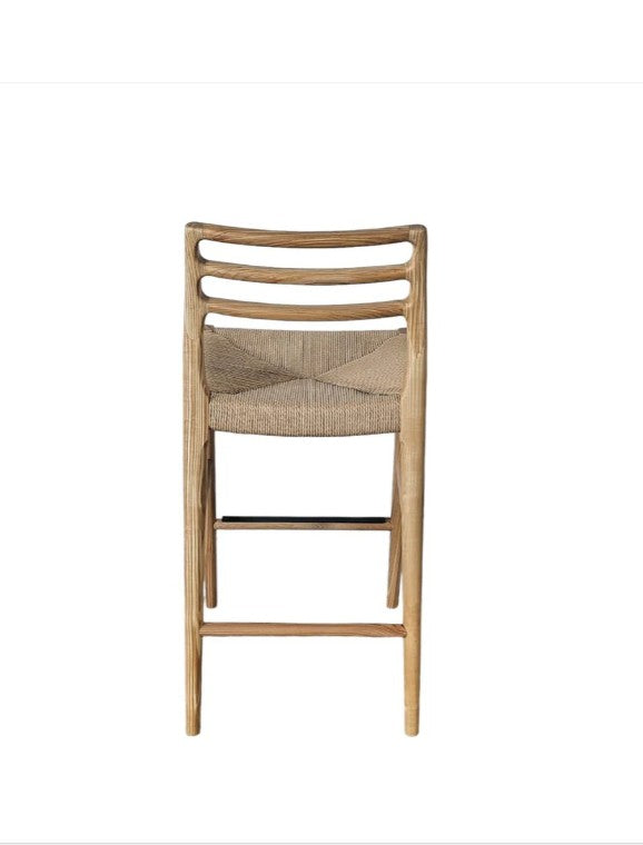 Wooden bar stool with woven seat on a white background