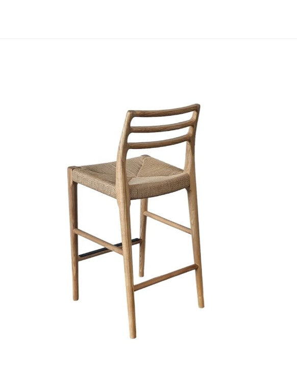 Wooden bar stool with woven seat on a white background