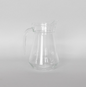 Clear glass pitcher on a light gray background