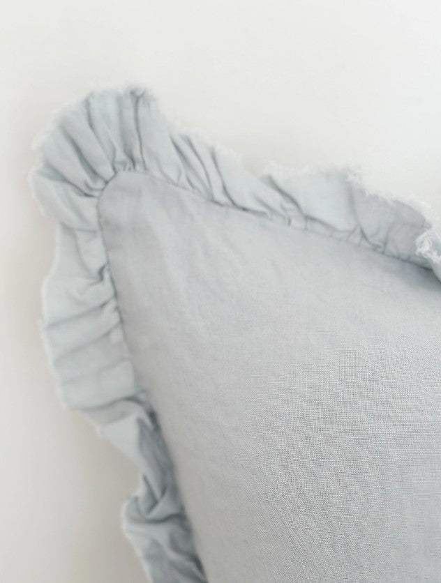 Light blue textured pillow on a white background