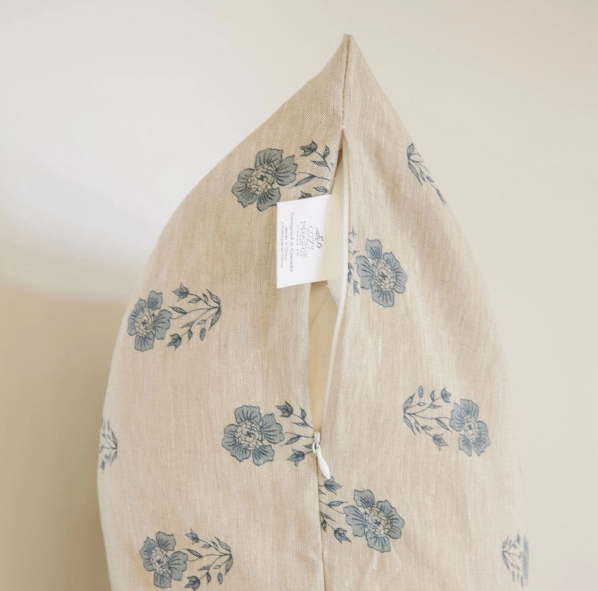 Beige fabric with blue floral patterns on a plain background