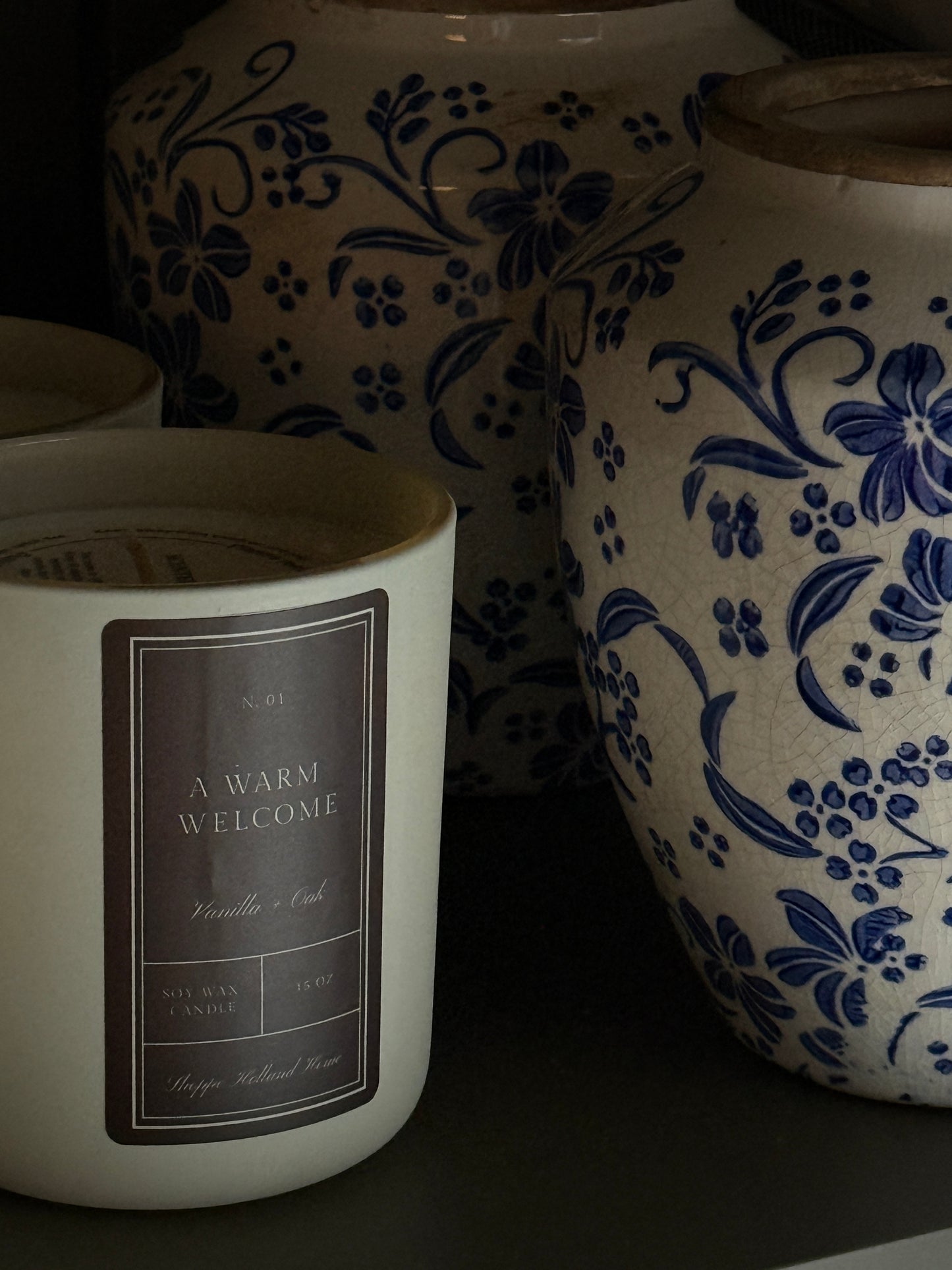 White container with floral design and text label on a dark background